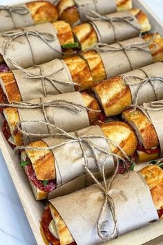 sandwiches wrapped in brown paper and tied with twine