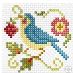 a cross stitch pattern with a blue bird and red flowers on it's side