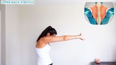 a woman standing in front of a white wall with her arm stretched out to the side