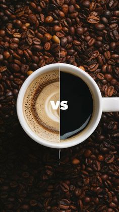 two cups of coffee sitting on top of a pile of coffee beans