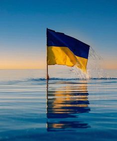 a flag is floating in the water on a sunny day