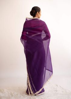 Editor's Note A pure silk organza saree in the shade of dark purple handcrafted with silver lampi borders. All the lampi borders are hand crafted and bring the reminiscence of old charm. Note: Blouse worn by model is for styling purposes only Fabric: Pure silk organza Color: Purple Components: Sari Length: 5.5 meters, width: 44 inches Fit: Free size Care: Dry clean only About the Designer A design house based on Indian craftsmanship, a perfect imperfection of a human hand and the labour of love. Elegant Purple Tissue Silk Pre-draped Saree, Purple Pre-draped Saree With Zari Work For Celebration, Purple Chanderi Pre-draped Saree For Wedding, Traditional Purple Tissue Silk Pre-draped Saree, Elegant Purple Chanderi Pre-draped Saree, Purple Organza Pre-draped Saree For Diwali, Traditional Purple Pre-draped Saree For Party, Purple Tissue Silk Pre-draped Saree With Sheer Dupatta, Purple Silk Pre-draped Saree For Wedding