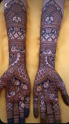 two hands with henna designs on them