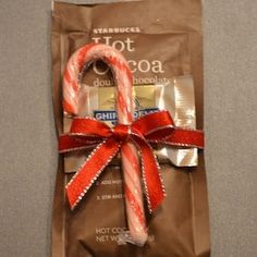 a candy cane wrapped in brown paper and tied with a red ribbon on the side