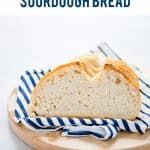 a loaf of bread on a plate with blue and white striped napkins next to it