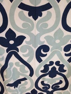 a blue and white wallpaper with an ornate design on it's side,