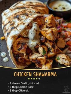 chicken shawarma on a plate with vegetables and sauce