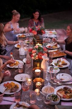 a group of people sitting around a table eating food