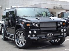 a black hummer is parked in the parking lot