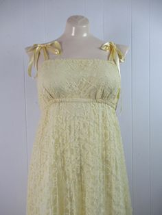 "Vintage 1960s or 70s summer prairie dress. Made of yellow acrylic lace with matching lace jacket. Dress has a yellow Rayon inner shell, empire waist, bow ties shoulder straps, elastic band above and below the bust. No designer label. Size small/medium. Dress measures: 35\" around the bust 21\"(stretches to 28\") at the elastic under the bust 42\" around the hips 48\" overall length Top measures: 37\" around the bust 37\" around the waist 13.5\" shoulder seam to shoulder seam 25\" shoulder seam 70s Dresses Formal Vintage, Vintage Yellow Prom Dress, 60s Empire Waist Dress, French Vintage Dress, 70s Sun Dress, 70s Dresses Formal, 60s Dresses Vintage, Yellow Dress Aesthetic, 1960s Prom Dress