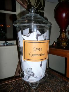 a glass jar filled with paper on top of a table