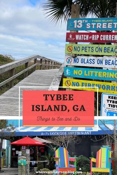 there are many signs on the beach and in front of this building that says tybe island, ga