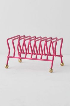 a pink rack with gold balls on it