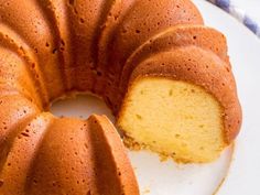 a bundt cake on a plate with one slice cut out