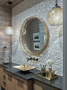 a bathroom with a sink, mirror and lights on the wall above it's counter