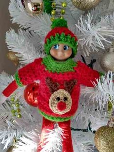 a red and green christmas ornament on a white tree