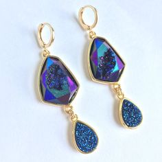 Blue Geode And Druzy Dangle Huggie Earrings ~Nwt Iridescent Blue Geode And Druzy Sparkle Like Glitter. Large Faceted Geode Gemstones Feature A Tear Drop Bezeled Druzy Dangle. Gold-Plated Bezel, Huggie Ear Wires, Resin Druzy, Geode Gemstone. Approx. Size: 2-3/8"L, 3/4"W *Gemstones Are Natural And No Two Are Alike. Shape And Color Differences Give Them Each Character. New, Nwt, Handmade By: Jpeace Designs New, Trendy, Handmade Jewelry, Droplet, Dangle Earrings, Natural Gemstone Hawaii Crafts, Sand Dollar Earrings, Coin Pearl Earrings, Michael Kors Earrings, Blue Geode, Tiger Eye Earrings, Engagement Earrings, Geode Earrings, Iridescent Blue