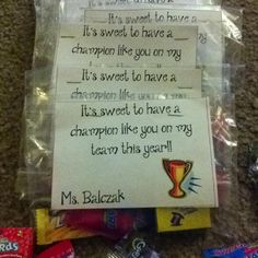 some candy bar wrappers are sitting on the floor with a note attached to them