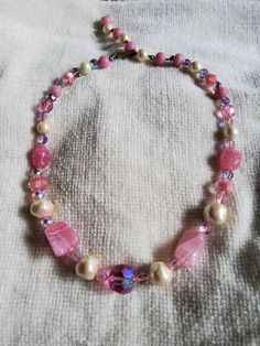 "Vintage Laguna Pink And Faux Pearl Necklace. Features AB beads as well as pink and clear givre beads along with pink swirl, faux pearl and AB beads with large pink AB bead at center. Has original vintage laguna grass clasp. Measures 18\" total length. Truly a unique find" Handmade Pink Pearl Beaded Necklaces, Pink Vintage Beaded Necklaces With Colorful Beads, Whimsical Pink Beaded Necklaces, Whimsical Pink Beaded Necklace, Whimsical Pink Round Beads Jewelry, Whimsical Pink Beaded Necklaces With Round Beads, Pink Pearl Jewelry With Faceted Beads, Vintage Pink Pearl Necklaces, Swirl Art