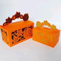 two orange boxes with decorative designs on them