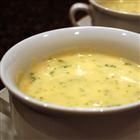 two white bowls filled with soup on top of a table