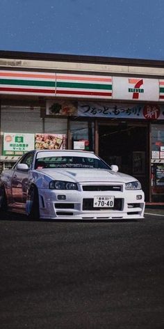 a white car parked in front of a fast food restaurant