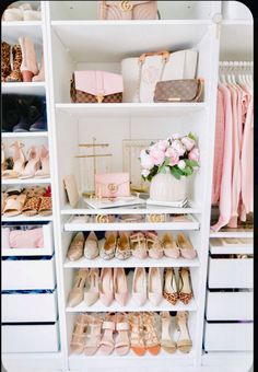 an organized closet with shoes, purses and other items on shelves in white drawers