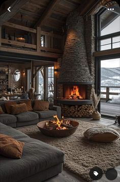 a living room filled with furniture and a fire place next to a large glass window