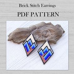 a pair of beaded earrings on top of a piece of wood with the words brick stitch