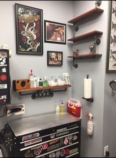 a room with various items on the wall and shelves above it, along with other items