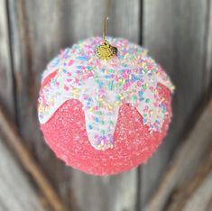 an ornament shaped like a donut with sprinkles on it