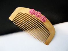 Eco friendly fine tooth bamboo hair comb for fine hair care. This bamboo comb is 3 and 3/4 inches long and 2 inches wide, and features 3 dusty pink resin roses. It is lightweight and its small size and curved edge make it easy to hold and handle. The teeth are sturdy but flexible, and not sharp at the tips. Running this comb through you hair will feel like a gentle massage. This pretty bamboo comb would be a lovely gift for a wedding, be it for the bridesmaid, bride, or flower girl. Hair accesso Bamboo Comb, Fine Hair Care, Fine Tooth Comb, Christening Gifts, Bride Wedding, Accessories Hair, Hair Comb, Pretty Hairstyles, Fine Hair