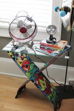 a table with a fan and some books on it