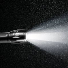 an image of a flashlight that is spraying water on the ground with it's head