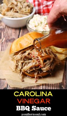 someone is pouring barbecue sauce on a pulled pork sandwich