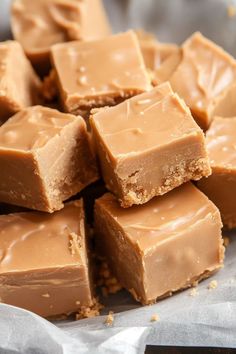 a pile of peanut butter fudges sitting on top of a piece of wax paper