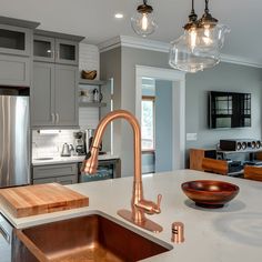 a modern kitchen with stainless steel appliances and marble counter tops