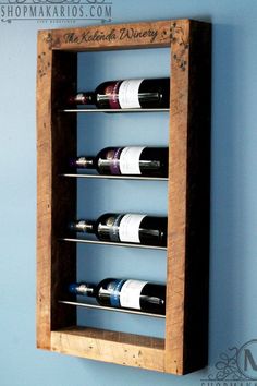 a wooden wine rack with six bottles on it