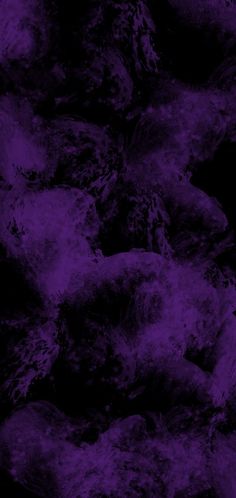 a bunch of rocks that are covered in some purple stuff on the dark side of the image