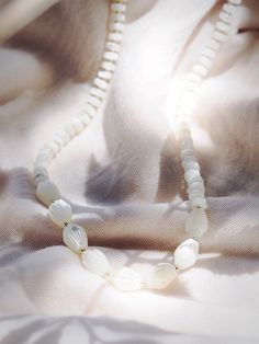 This white mother of pearl pikake shell necklace evokes visions of Hawaii's flower leis and reflect Hawaii's natural abundance. This unique beauty is ready for you and your tropical escape. ✦ DETAILS ✦✧ Name: Mau loa (maow LOah) - always and forever.✧ White Mother of Pearl beads.✧ 14kt Gold Filled clasp and beads.✧ All Ke Aloha Jewelry pieces come packaged thoughtfully, beautifully, and ready for gift giving. Delicate White Mother Of Pearl Necklace, Spiritual White Mother Of Pearl Jewelry, White Single Strand Mother Of Pearl Necklace, Mother Of Pearl Shell-shaped Necklace In Pearl White, Pearl White Mother Of Pearl Shell-shaped Necklace, White Mother Of Pearl Round Bead Necklaces, White Mother Of Pearl Spiritual Necklace, White Adjustable Shell Necklace Spiritual Style, Adjustable White Pearl Necklace With Natural Stones