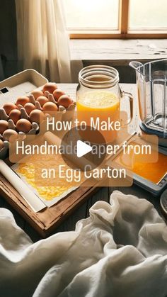 an egg carton sitting on top of a table next to eggs and orange juice