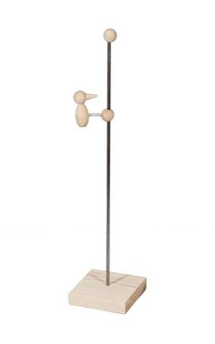 a wooden and metal pole with two balls on it's end, in front of a white background