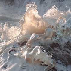 the water is splashing on top of the foamy waves in the ocean,