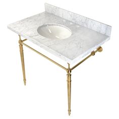 a white sink sitting on top of a marble counter next to a gold metal frame