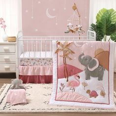 a baby crib bedding set with an elephant on it