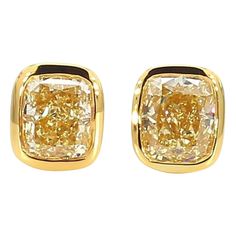 RareGemWorld's classic GIA certified diamond earrings. Mounted in a beautiful 18K Yellow Gold setting with natural cushion cut yellow diamonds. These earrings are guaranteed to impress and enhance your personal collection! Total Weight: 1.46cts Natural Fancy Light Yellow Cushion Cut Diamond Measurements: 5.63 x 4.84 x 3.13 mm Carat Weight: 0.73cts Clarity Grade: VS2 Natural Fancy Light Yellow Cushion Cut Diamond Measurements: 5.35 x 4.54 x 3.33 mm Carat Weight: 0.73cts Clarity Grade: VVS2 18K Yellow Gold All diamonds are guaranteed natural International Shipments: Please note that customers are responsible for all import duties and taxes applicable to the country of shipment Returns: Returns accepted in original format within 14 days of receipt Do not forget to view our entire inventory! T Yellow Diamond Earrings, Classic Diamond Earrings, Yellow Diamond Earring, Earring Video, Yellow Cushion, Fancy Light, Yellow Cushions, Yellow Diamonds, Natural Cushions