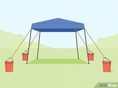 a blue tent with buckets on the ground and two red buckets under it