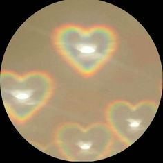 two hearts are shown in the middle of a circular image with light coming from them