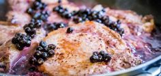 meat and berries cooking in a pan on the stove