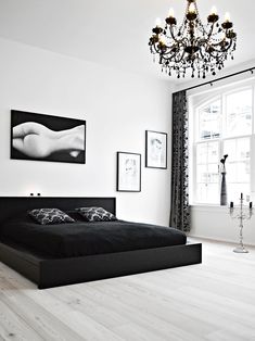 a black and white bedroom with a chandelier